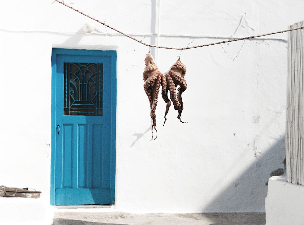 Golden Beaches and Iconic Blue-and-White Houses